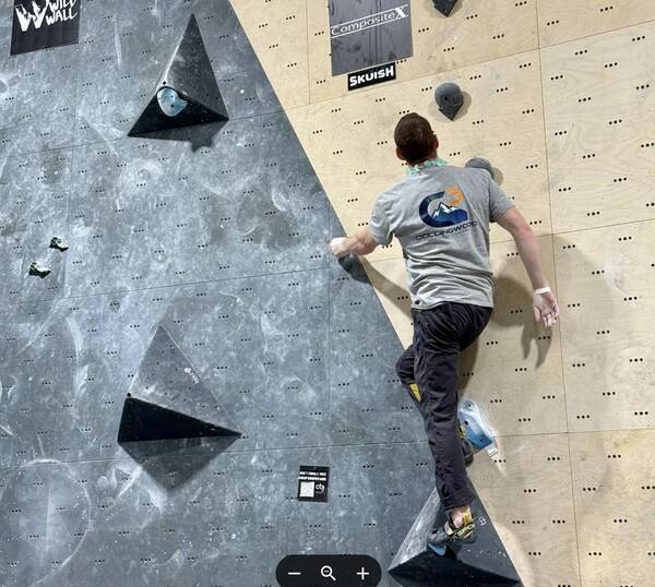 A climber working a route on the indoor bouldering wall